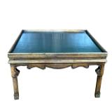 LEATHER TOP COFFEE TABLE | Low table having a green leather top with embossed gilt border and carved