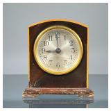 SETH THOMAS DESK CLOCK | Having a domed case in contrasting woods, the face with Arabic numerals. - 