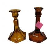 two amber glass candlesticks