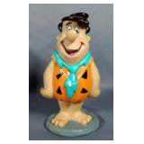 Coin Banks Including Vinyl California Raisin And Fred Flintstone, Fred Is Missing Stopper, Glass Sno