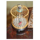 Vintage Hexagonal Table with Decorative Items: Tray, Picture Frame, Birdcage, and Wicker Basket