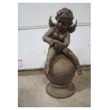 Angel cherub on ball statue