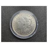 1921 Uncirculated Morgan Dollar. Strong Definition of Hair Above Ear and Breast Feathers, Bagmarks Typical of MS62