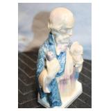 Handcrafted Ceramic Figurine with Blue Robe Detailing