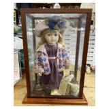 Porcelain doll with accessories in case in glass