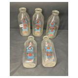 Five THOMPSONï¿½S milk bottles