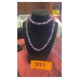 Here is a Necklace of Purple Glass Beads