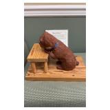 Ravels prays , dog clay sculpture on pine wood