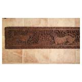 Carved wooden plaque, of a crouching lion and two