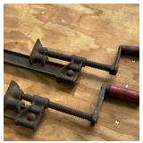 Two antique metal bar clamps