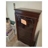 Antique wooden cabinet with glass door and