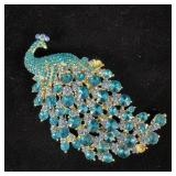 Large designer peacock brooch missing two stones