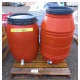 Two plastic barrels with hose connections