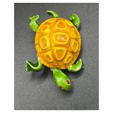 Vintage turtle brooch with red eyes.