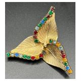 Vintage three leaf brooch w colorful rhinestones.