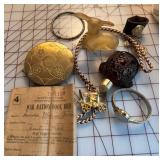 Brass compact, war ration book, Avon perfume