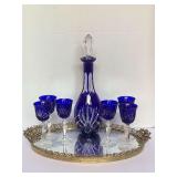 VINTAGE NACHTMANN BAVARIAN COBALT BLUE CUT TO CLEAR DECANTER 12 1/2" TALL WITH 6 STEMMED CORDIALS 5" TALL ON VINTAGE OVAL BRASS TRAY WITH MIRROR BOTTOM - LIVING ROOM