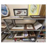 Metal shelf content, content only, includes vintage framed, and framed and matted artwork, approximately 10 pieces of artwork, also includes assorted new coffee mugs, assorted pans, insulated market t