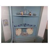 CONTENT OF CABINET CLEAR GLASS CUPS WITH BLUE HANDLES, CLEAR CRYSTAL BALL, TWO FLORAL PLATES, PILGRIM STATUES, AND MORE