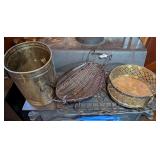 ALL ITEMS ON LOWER LEVEL OF STOVE INCLUDING VINTAGE BRASS CAN, MODERN WOVEN METAL FRAME BASKET, HEAVY METAL BRASS PLANTER STAND, AND METAL TRAY