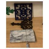 2 CAST IRON TRIVETS & MARBLE CHEESE SLICER - BREAKFAST AREA