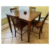 Kitchen… Coaster high top table with four slat back chairs, table surface does have wear, see pictures for details.