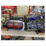 4 collector sports cars in boxes