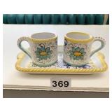 PAIR OF SMALL HAND PAINTED CUPS ON SMALL HAND