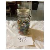 Large glass jar of marbles