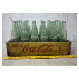 Case of coke bottles with crate