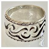 Wide sterling silver ring with cut-out scroll