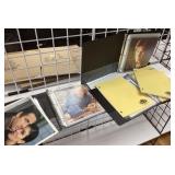 Binders with head shots, photos, and scripts