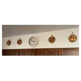 Copper molds and clock on kitchen wall