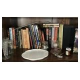 Contents of shelf with books and milk glass vase