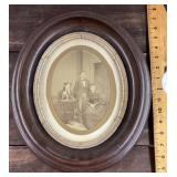 Antique family photo in oval walnut frame