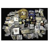 Large group of police pins and patches