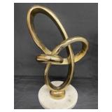 Gold-tone abstract metal on marble base