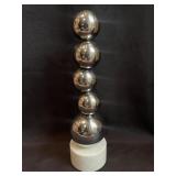 Abstract metal bubble on marble base