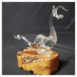 Hand blown baby glass dragon sculpture on a burl