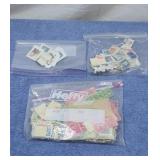 Postage stamps in 3 zip lock bags.