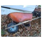 Vintage metal wheelbarrow with wood handles