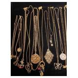 Gold tone necklaces with large pendants
