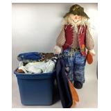 Straw stuffed scarecrow, throws and blankets in