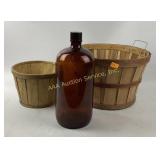 Large amber glass jug and wood baskets