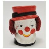 Clown head vase with ear muffs 4 3/4", some