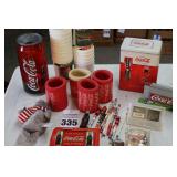 Variety of Coca-Cola items: 4 coke cozies, "Max Headroom plastic cups (15+)  - tin- playing cards in tin box - pencil sharpener - light - stuffed animal etc.