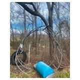 Round Bale Feeder, Plastic Barrel, and Tractor Tire