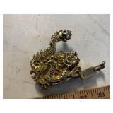 Tattoo gun with brass dragon embellishment