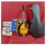 Fender mandolin case and book music