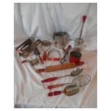 Group of red handled vintage kitchen utensils